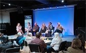 Photo of housing and land use panelists on stage.