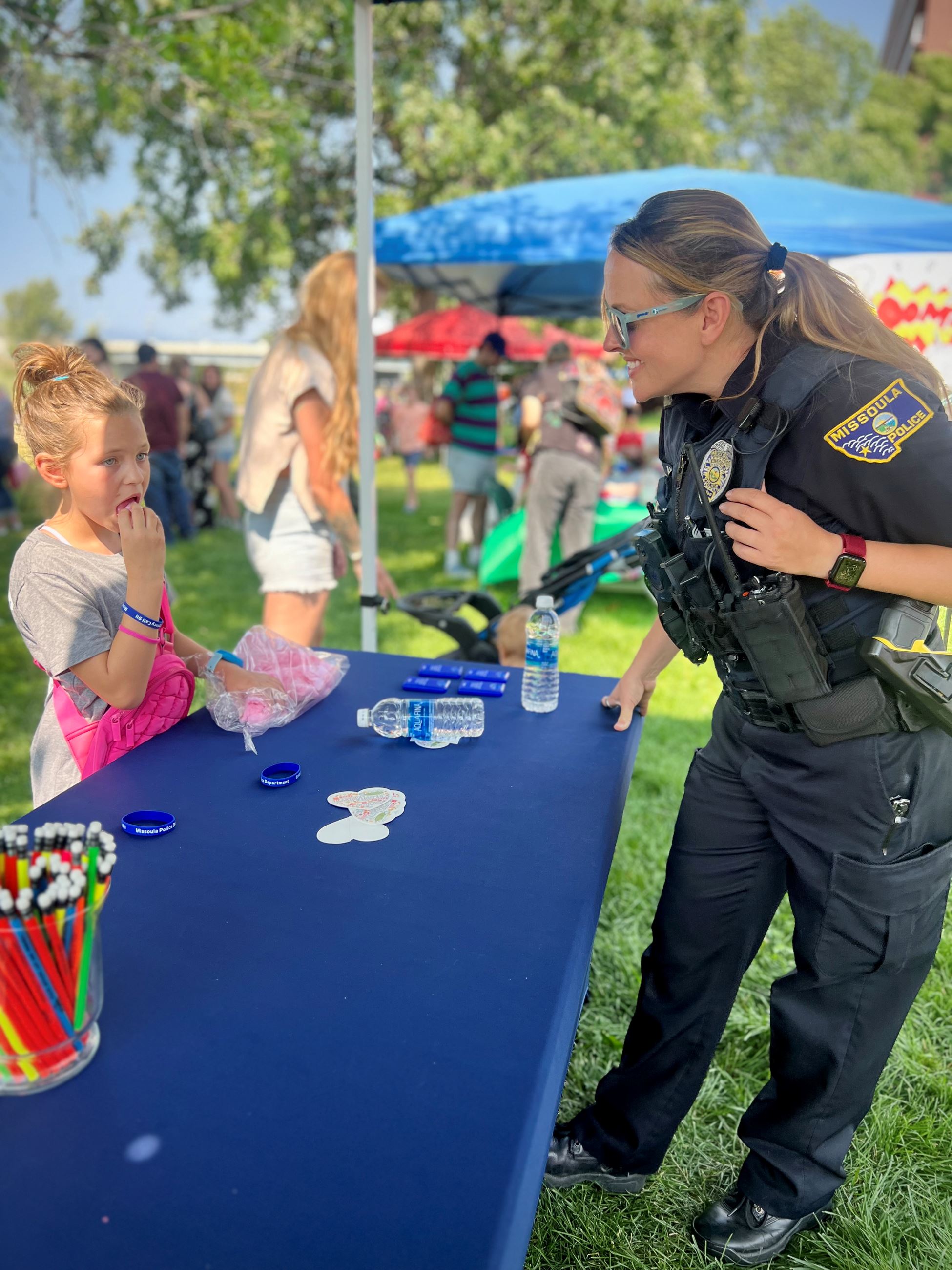 Officer Arnold with child at the Fairytale & Superhero Festival